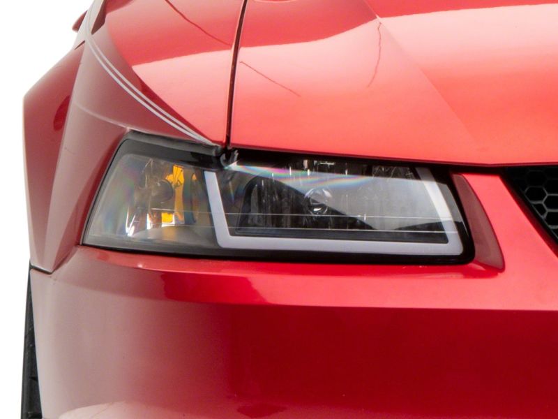 Raxiom 99-04 Ford Mustang Axial Series Headlights w/ Sequential LED Bar- Black Housing (Clear Lens)