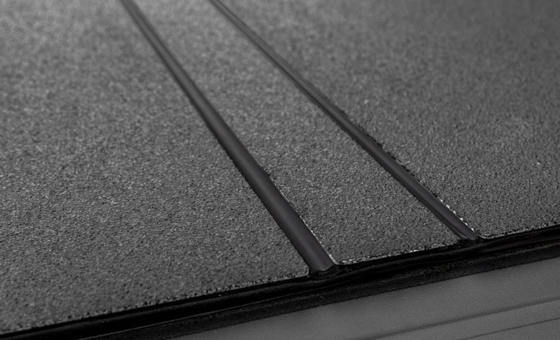 Access LOMAX 2022+ Rivian R1T 4ft 6in Bed (w/ OEM Tonneau Track) Folding Hard Cover - Black Urethane